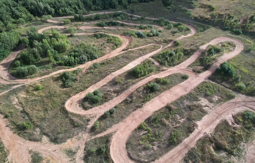 offroad,track,for,motocross,on,bright,sunny,day,aerial,view